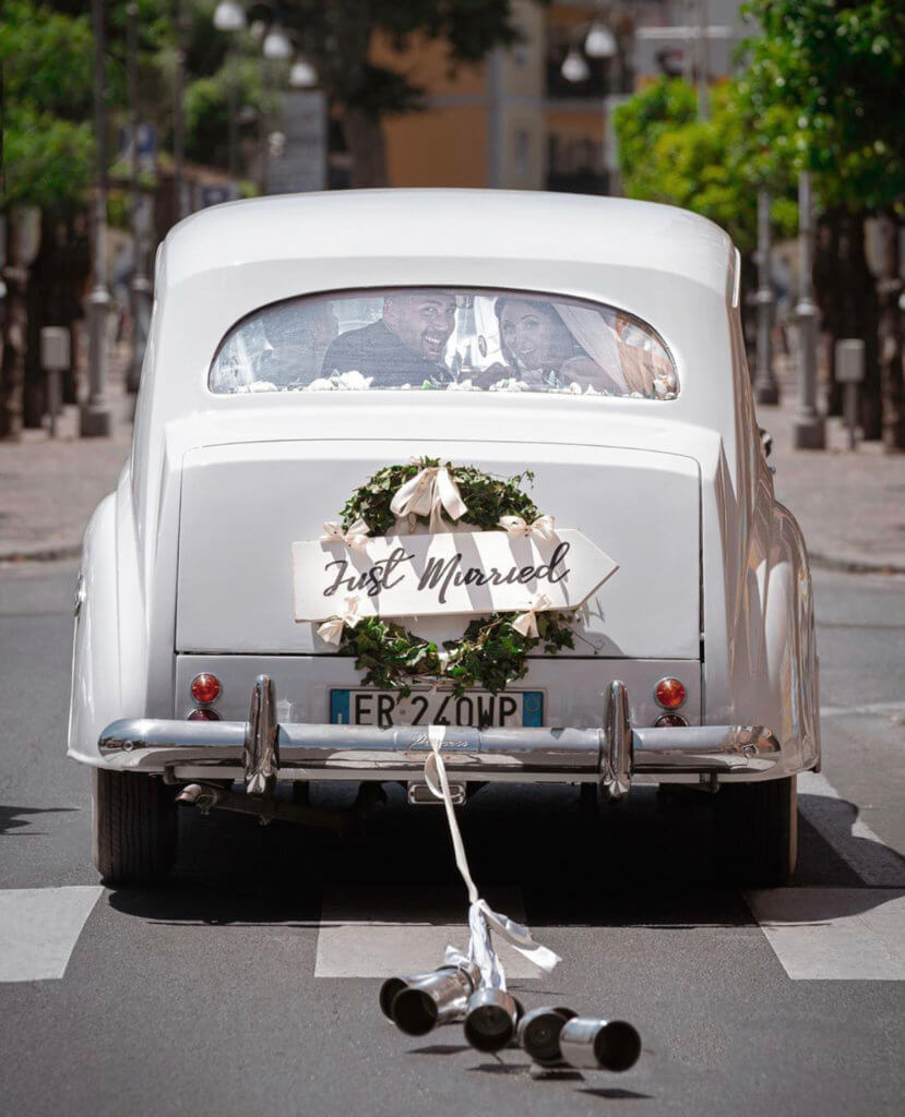 just married couple in a white classic car