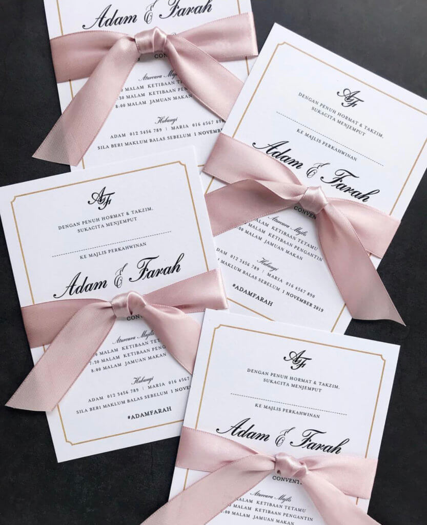 wedding invitation cards tied with a bow